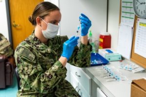 Navy Lt. Courtney Corcoran prepares vaccine syringes at a community vaccination site in Somerset, NJ, at a Federal Emergency Management Agency mass vaccination site. Photo by K.C. Wilsey/FEMA